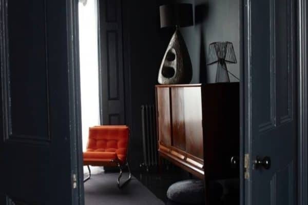 Peeping through into the deliciously dark room with that orange Barcelona chair. Eye popping. 

Pic by Lombard8